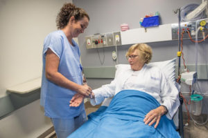 urse and patient in pre-op bay, awaiting a permanent pacemaker procedure